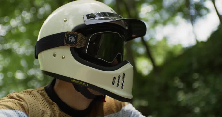A motorcyclist rides in a forest