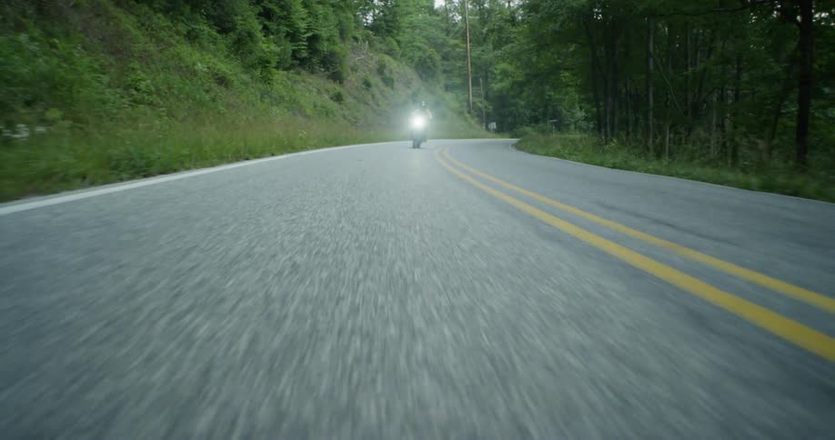 A motorcycle is driven on a rural road