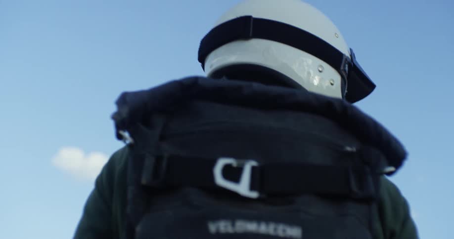 A man walks in a motorcycle helmet
