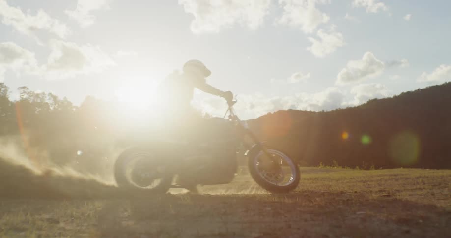 A man spins out on a dirt bike