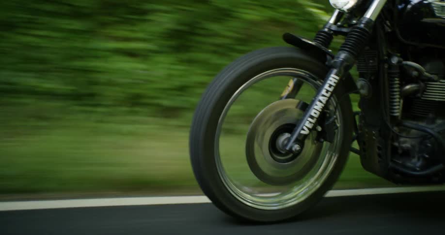 Motorcycle travels near the edge of the road