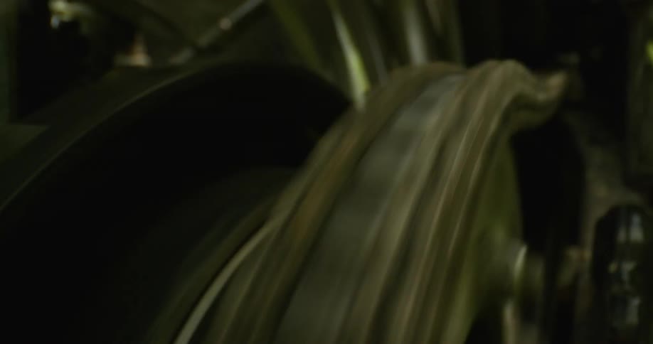 A chain and wheel turn and then stop