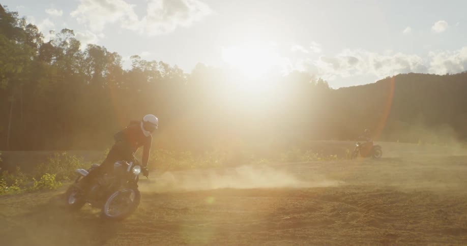 A dirt bike skids on the dirt
