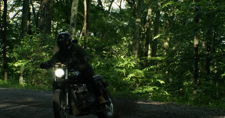 A rider kicks up dirt when making a turn on a motorcycle