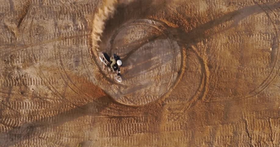 Motorcycle spins around in the dirt