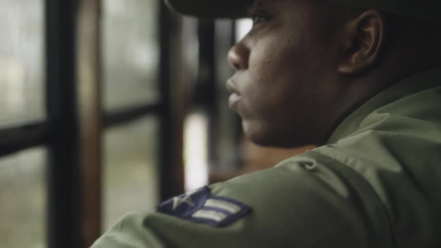 A soldier rides on the bus