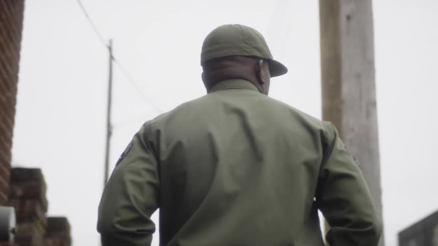 An airman walks in a town on a cloudy day