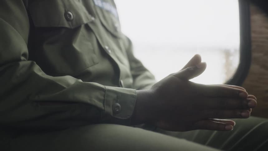 A service member rides a bus