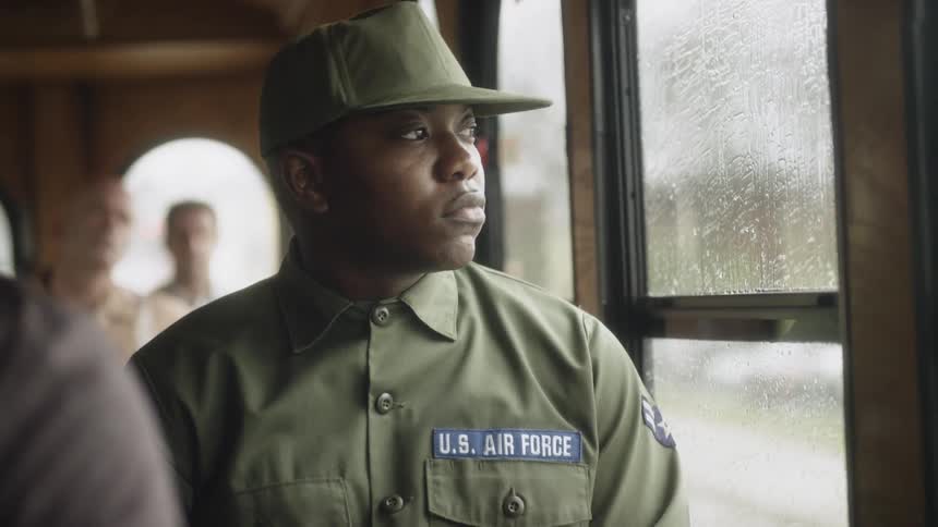 A soldier rides on the bus
