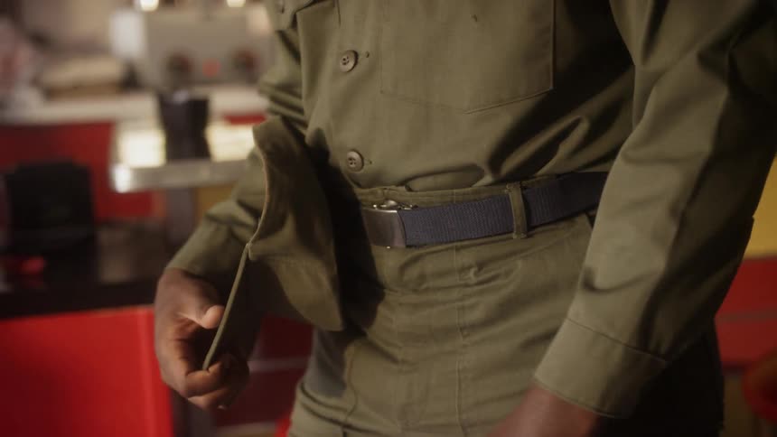 A soldier walks inside a diner