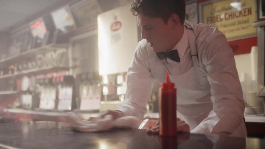 A man cleaning the counter stops a black airman who entered the diner