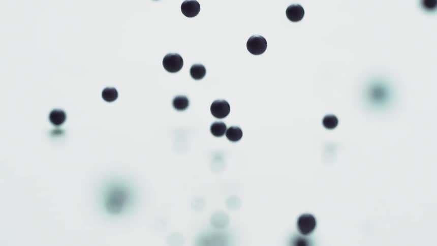 Blue balls drop and bounce on a white surface