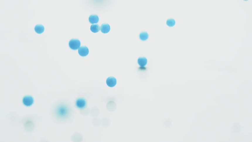 Blue balls bounce on a white surface