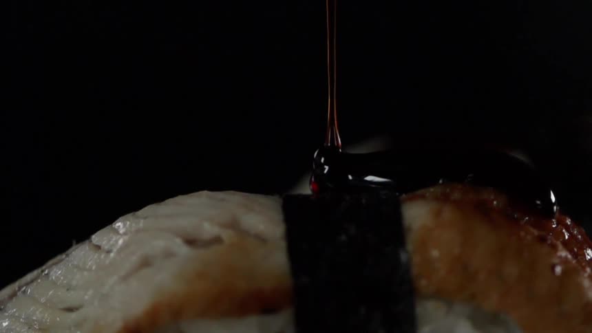 Liquid falls on a piece of sushi