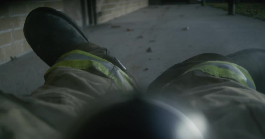 A firefighter is dragged on the sidewalk