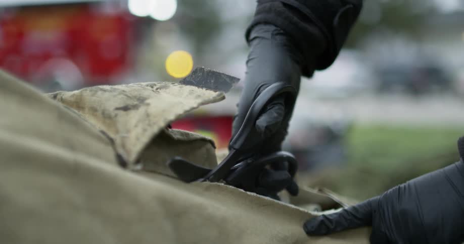Emergency medical technician is cutting a person's clothes