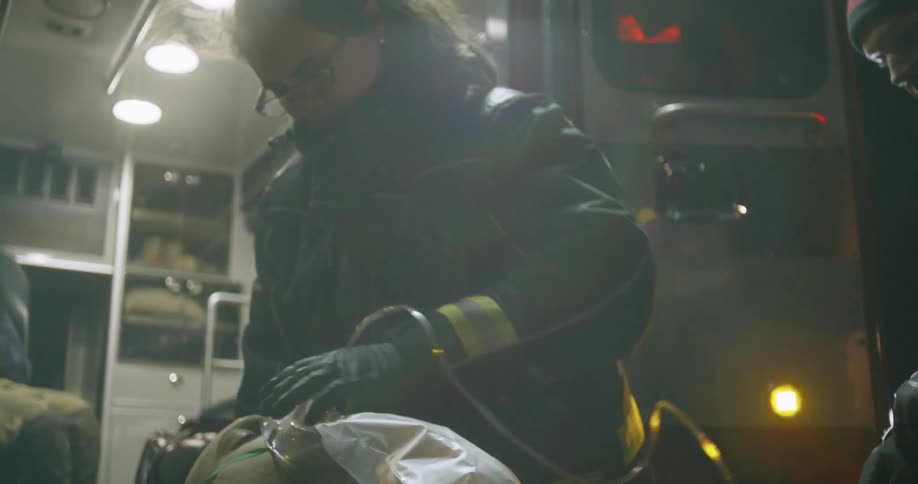 A rescue worker gives oxygen to a man