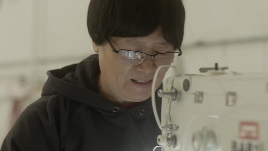 A man works at a sewing machine