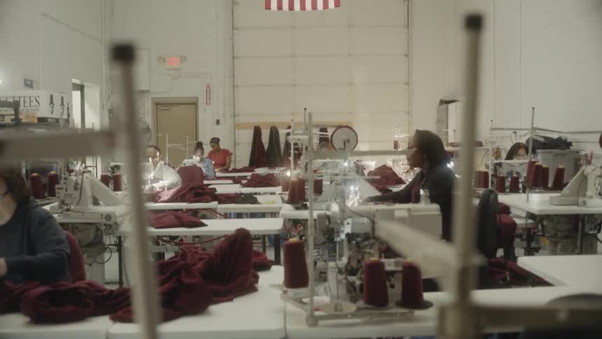 An american flag hangs in a factory