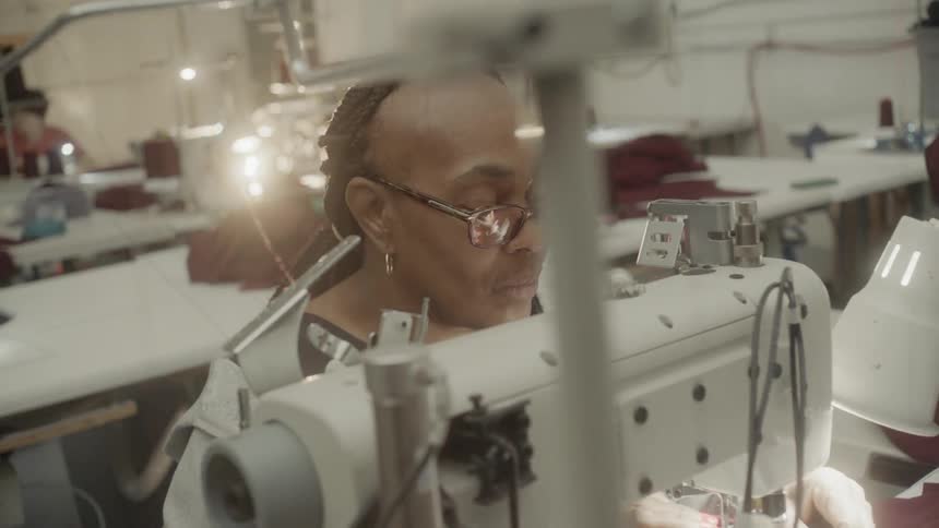 A seamstress works in a factory