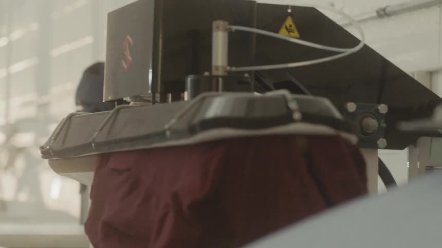 Clothing is pressed at a dry cleaners