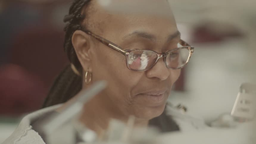 A woman works at a sewing machine