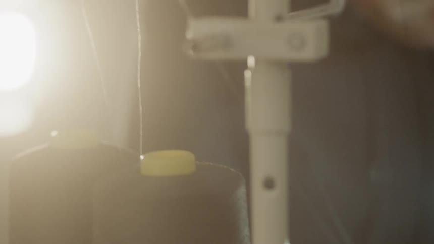 Light shines on spools of thread