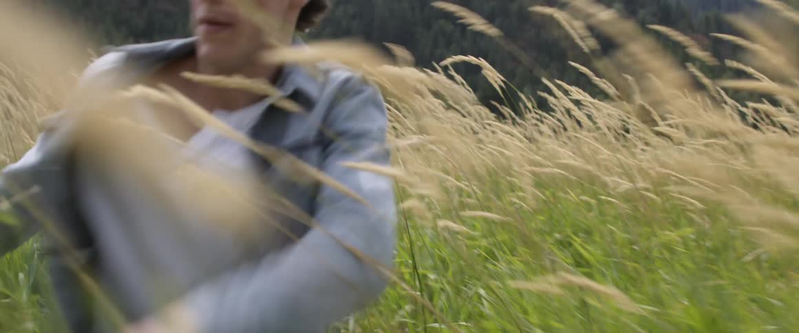 A man races through the tall grass