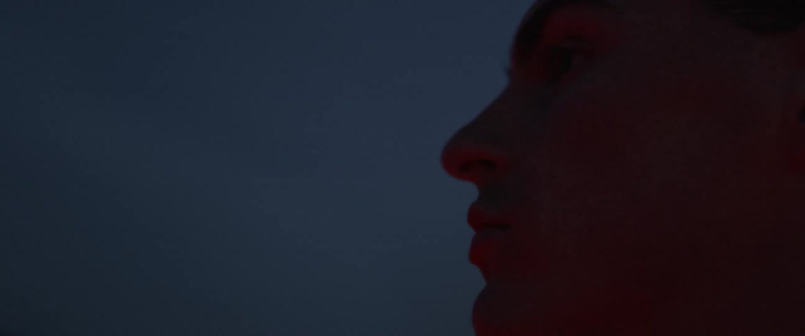 A man looks at the sky at dawn