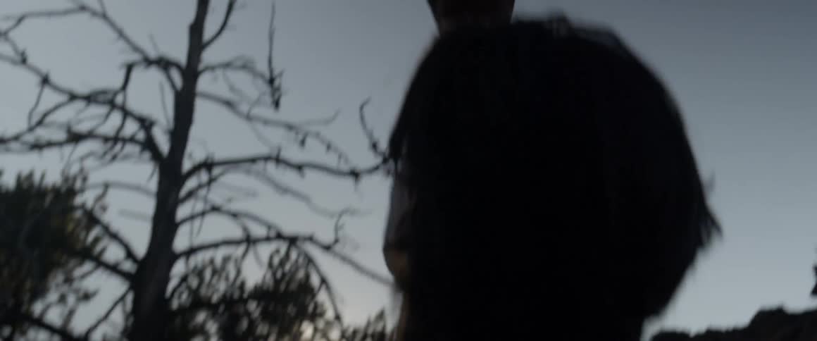 A man tosses a rock up in the air and catches it