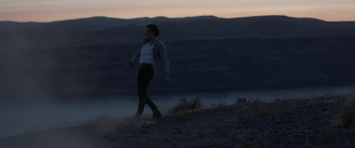 A man kicks dirt in anger