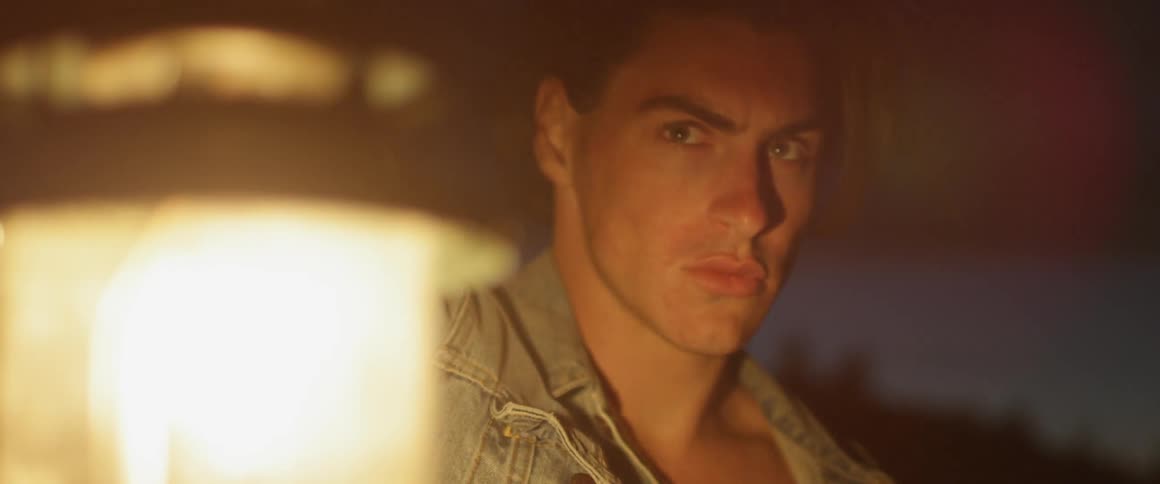 Man holds a lantern as he looks around