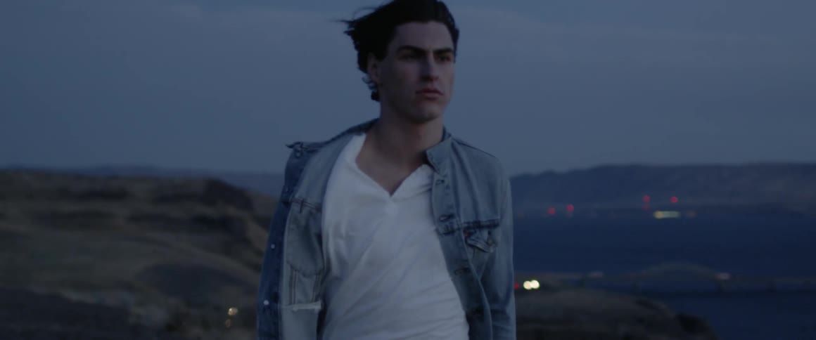 The breeze blows the man's hair as he walks