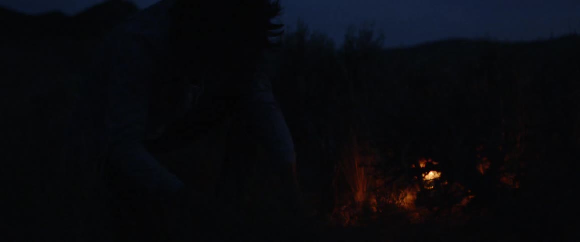 A man camps outside at night
