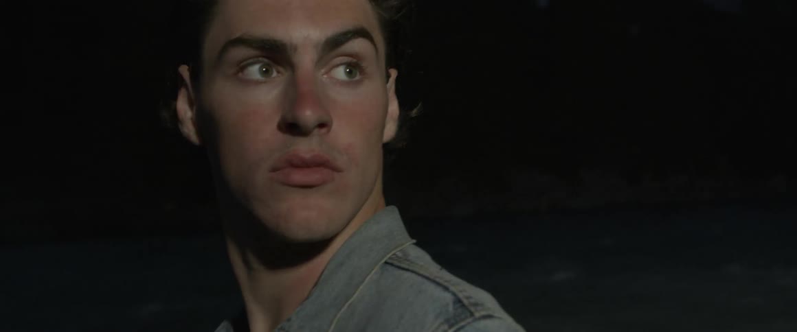 Man looks behind him as a light shines