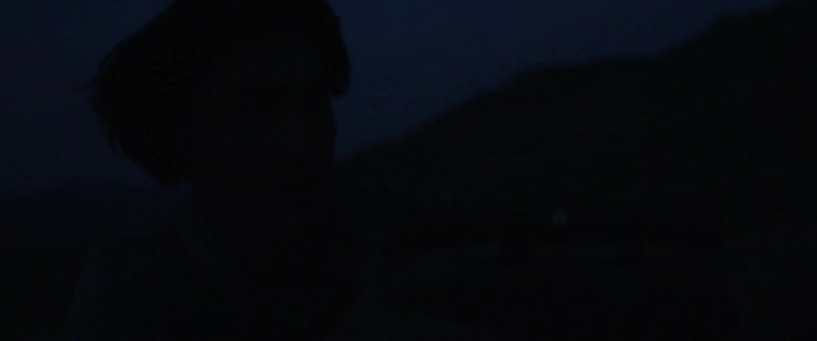 A person is moving around in the dark