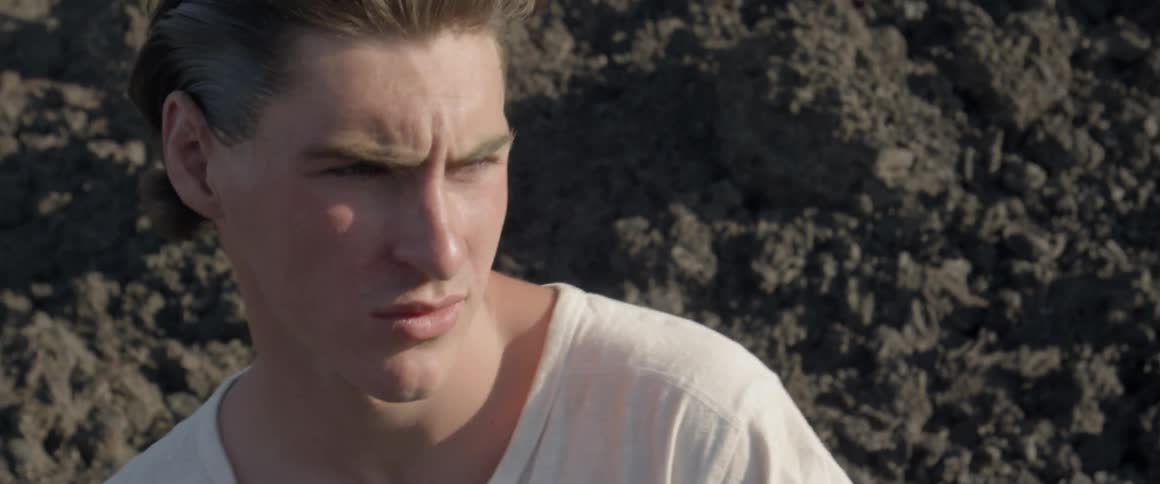 A man looks around outside on a sunny day