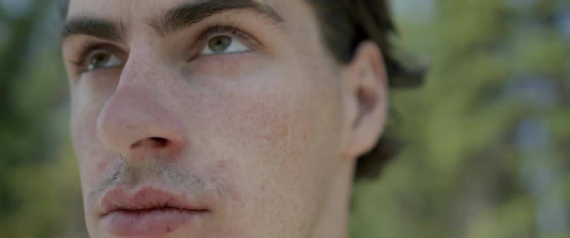 Man blinks as he looks around