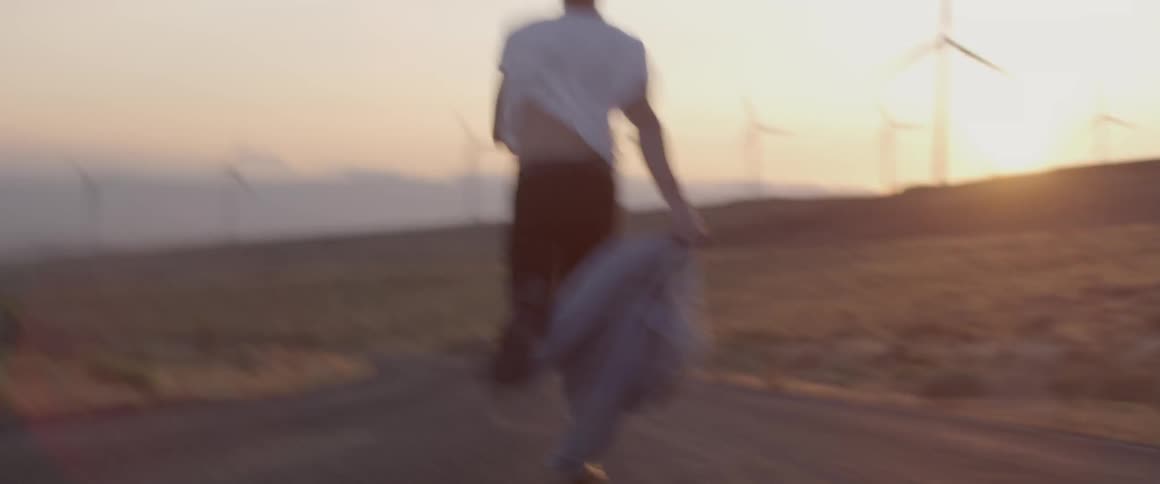A man races down the trail at sunset