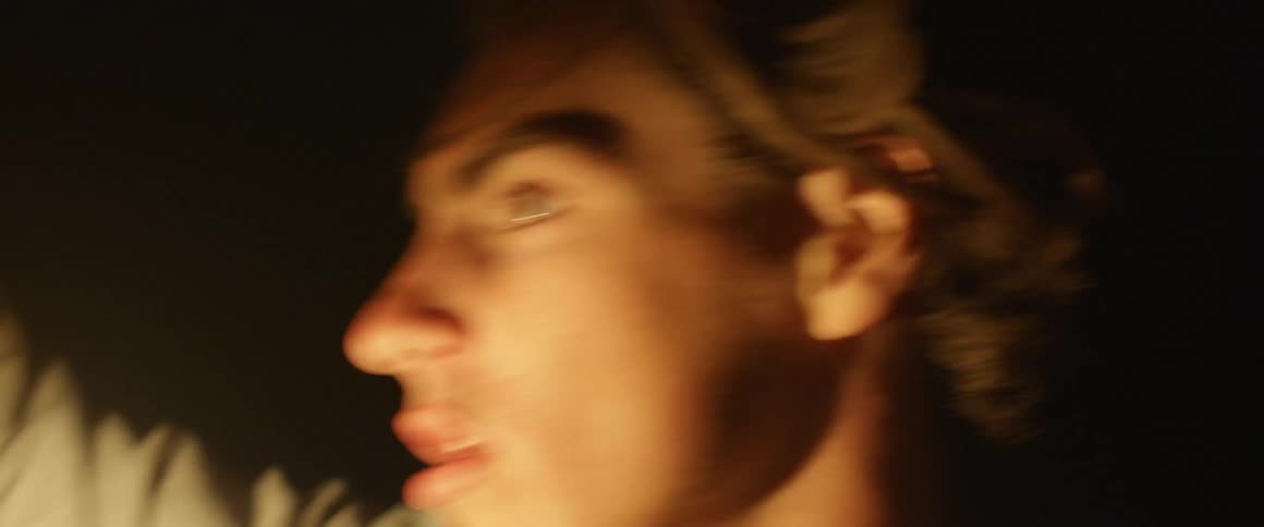 A man uses a lantern to search at night