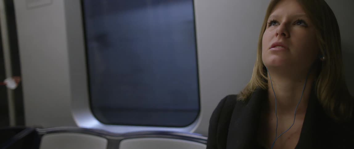 An upset woman rides the subway