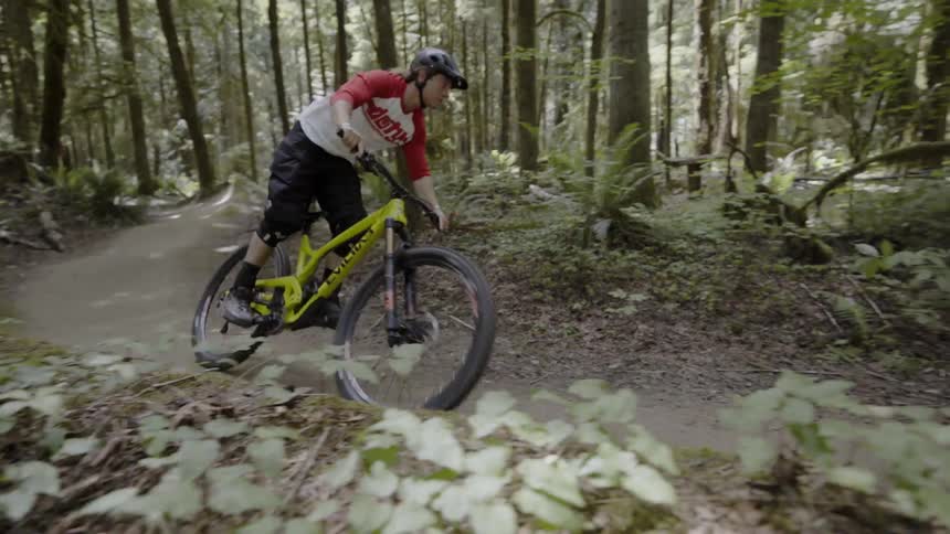 Man rides a bicycle on a path in the forest