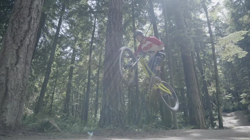 A man jumping a bicycle is photographed