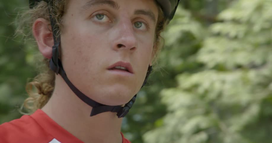 A man straps on a bicycle helmet