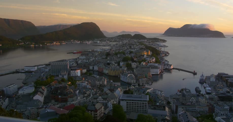 A view of an island city that is surrounded by water and mountains