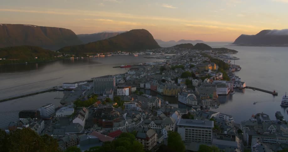 The sun sets over a coastal town