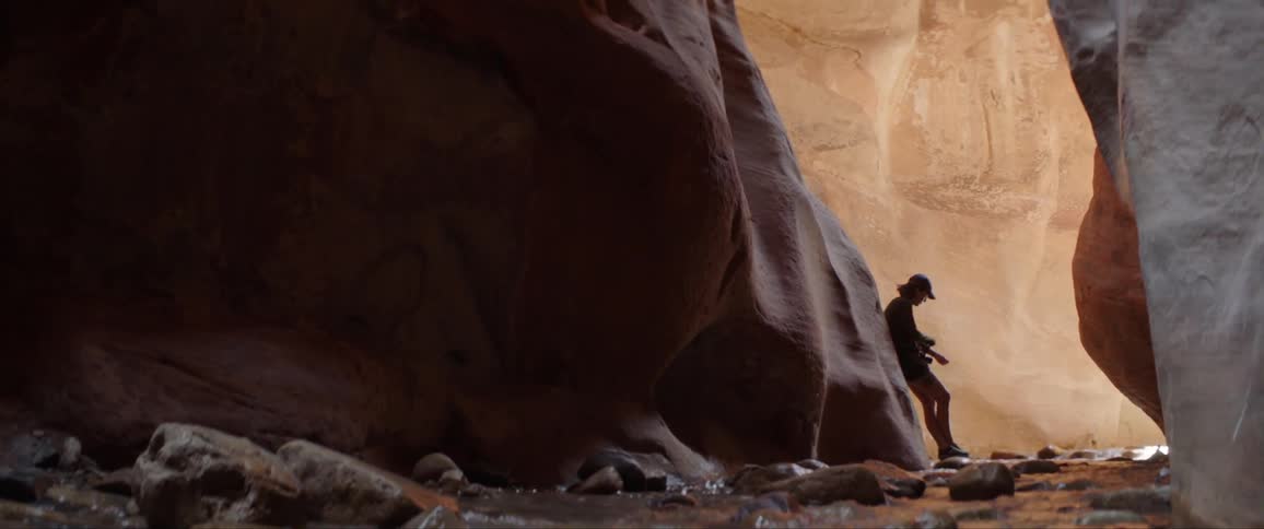 A woman takes photographs from inside a cavern