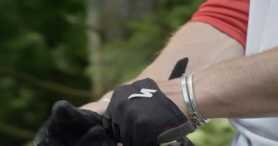 A man puts motorcycle gloves on