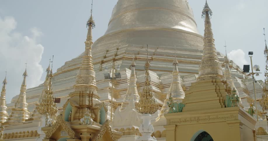 The building is gold with pillars around