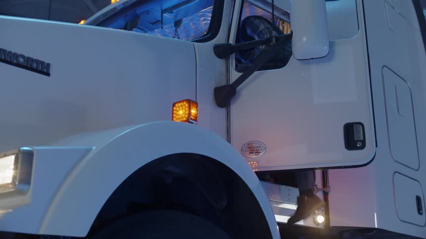 A truck driver enters a truck